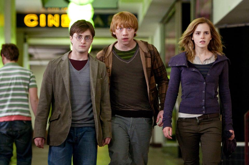 Harry Potter, Ron Weasley, and Hermione Granger walking together.