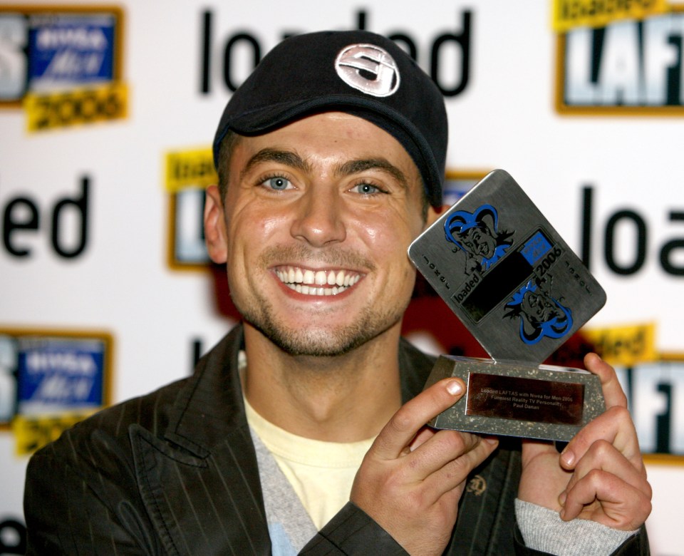 Paul Danan holding his Funniest Reality TV Personality award.