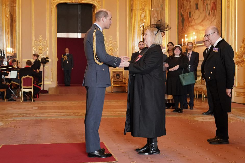 Prince William presenting Pauline Quirke with an MBE at Windsor Castle.