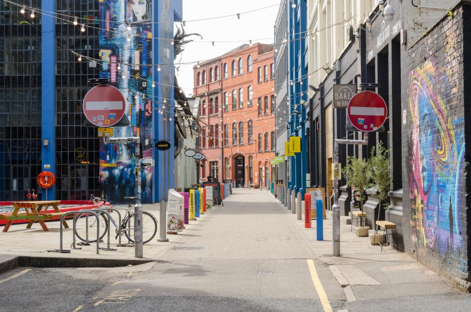 No entry street in Birmingham's creative quarter, featuring street art and businesses.