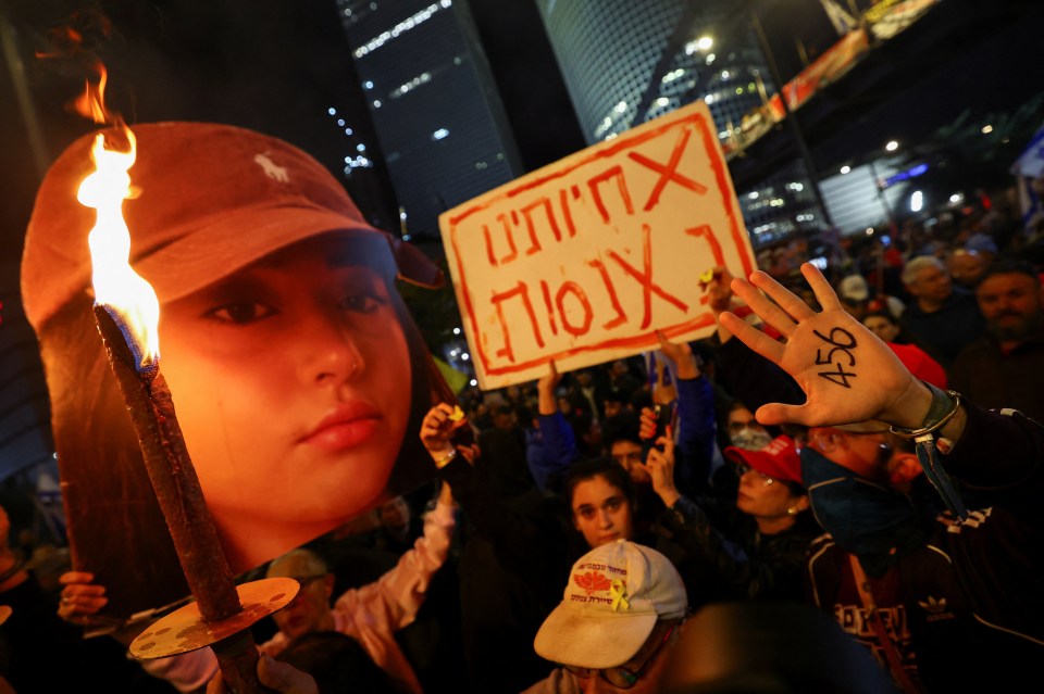 A cutout of Albag's head being held by protesters