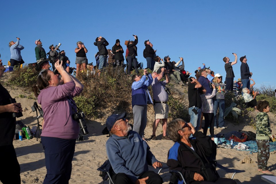 People watching a SpaceX Starship rocket launch.