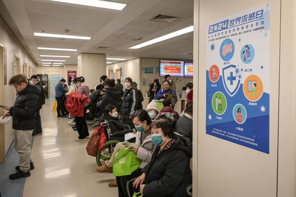 People wearing masks wait in a hospital outpatient area.