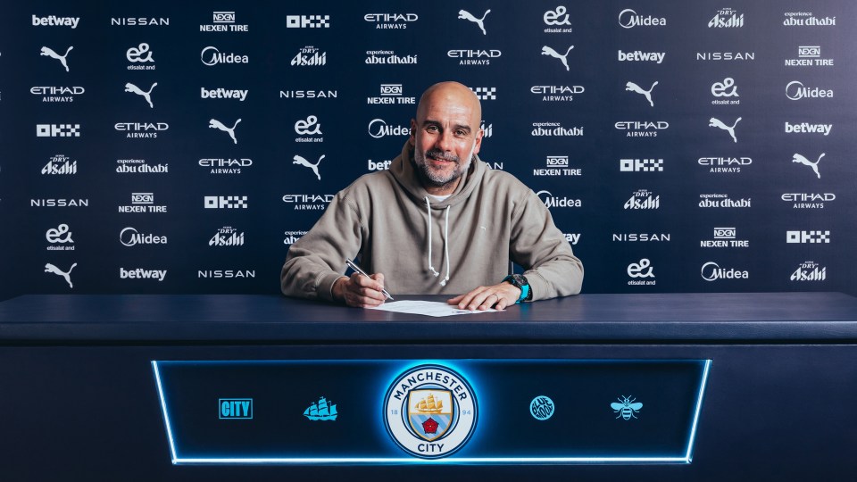 Pep Guardiola signing a Manchester City contract extension.