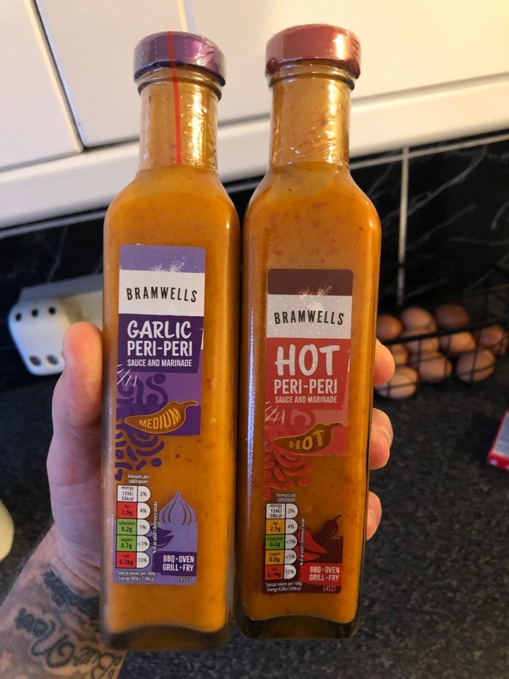 Two bottles of Bramwells peri-peri sauce; one garlic, medium; one hot.