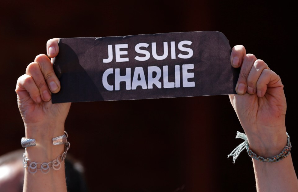 A person holds a sign that reads in French 'I am Charlie' during a gathering in solidarity