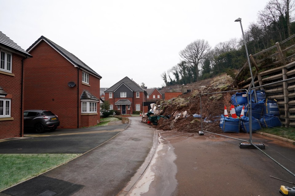 Landslide blocking road access to homes.