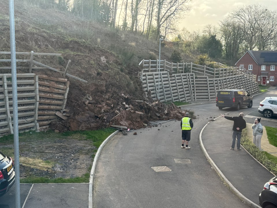 Massive landslip blocking a road and damaging retaining walls.