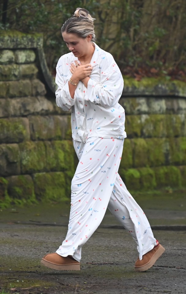 Woman in pajamas walking outdoors.