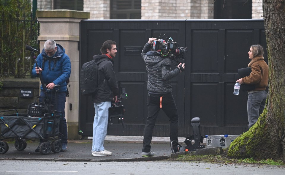 Film crew filming outside a house.