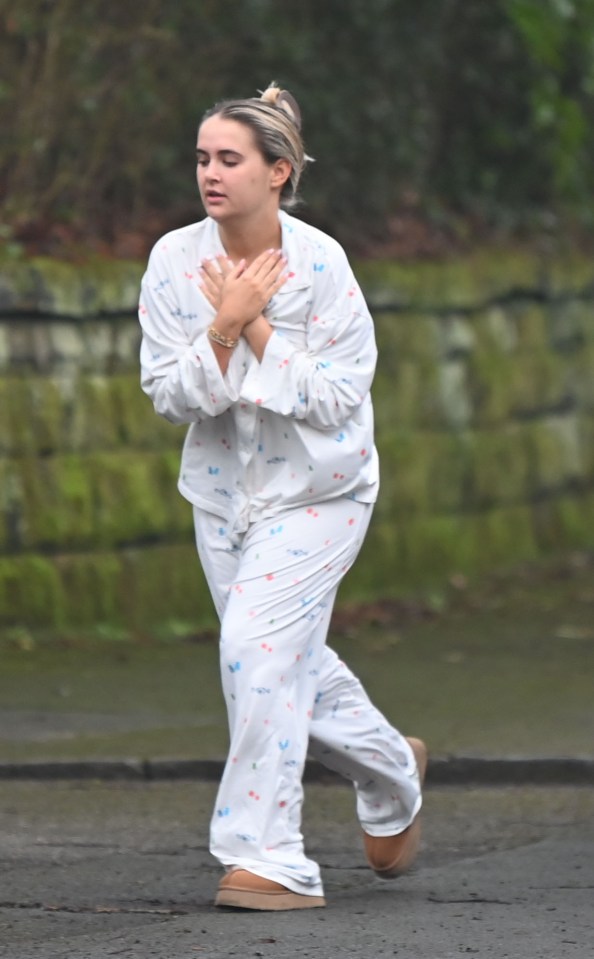 Woman in pajamas walking.