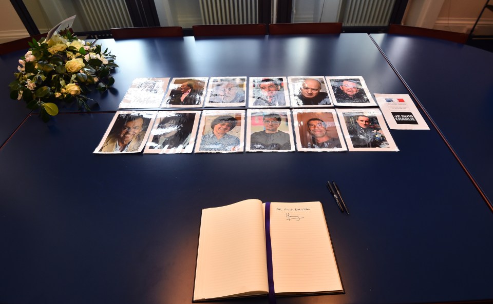 Picture shows pictures of the 12 victims and the message and signature written by Britain’s Prince Harry in a book of condolence at the French embassy