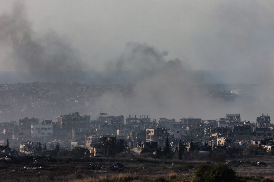 Picture shows smoke rising above destroyed buildings in the northern Gaza Strip during Israeli bombardment