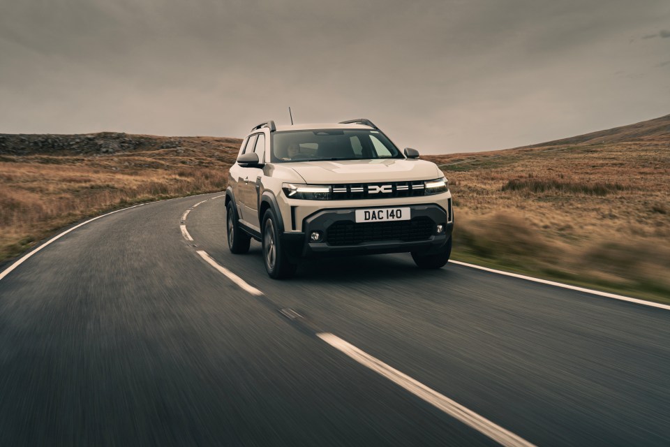 Dacia Duster driving on a road.