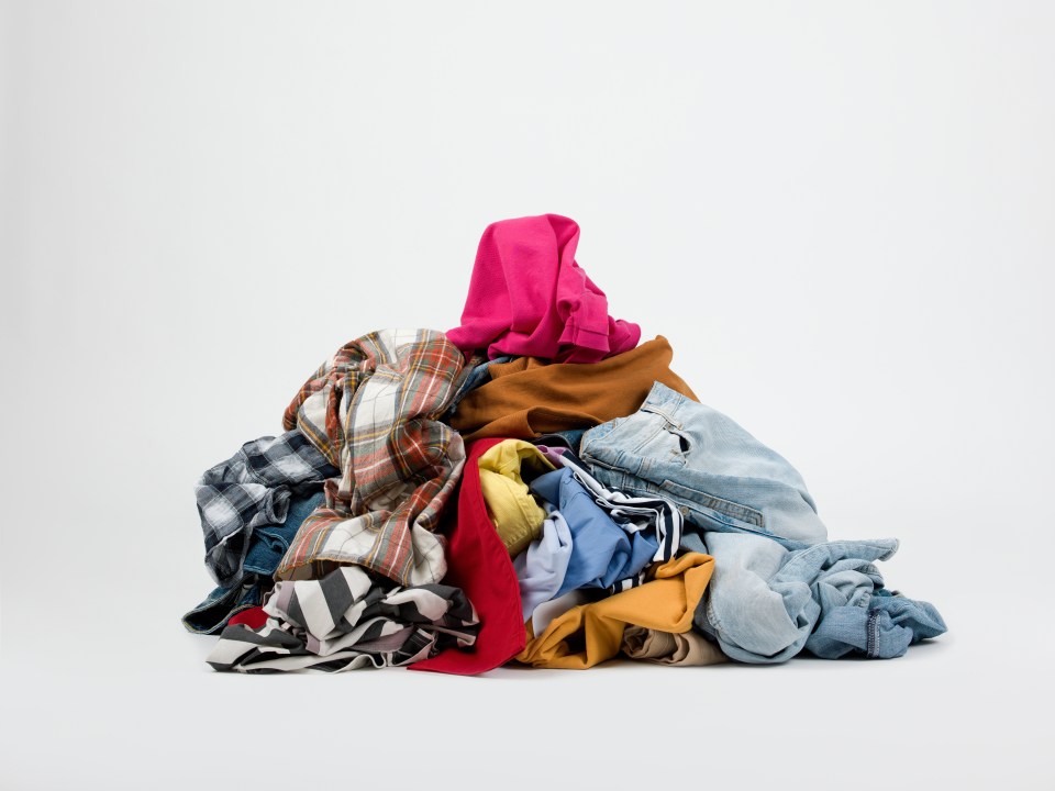 A large pile of laundry on a white background.