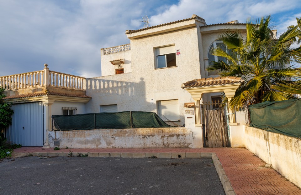 Police tape on the door of a villa used as a cannabis farm.