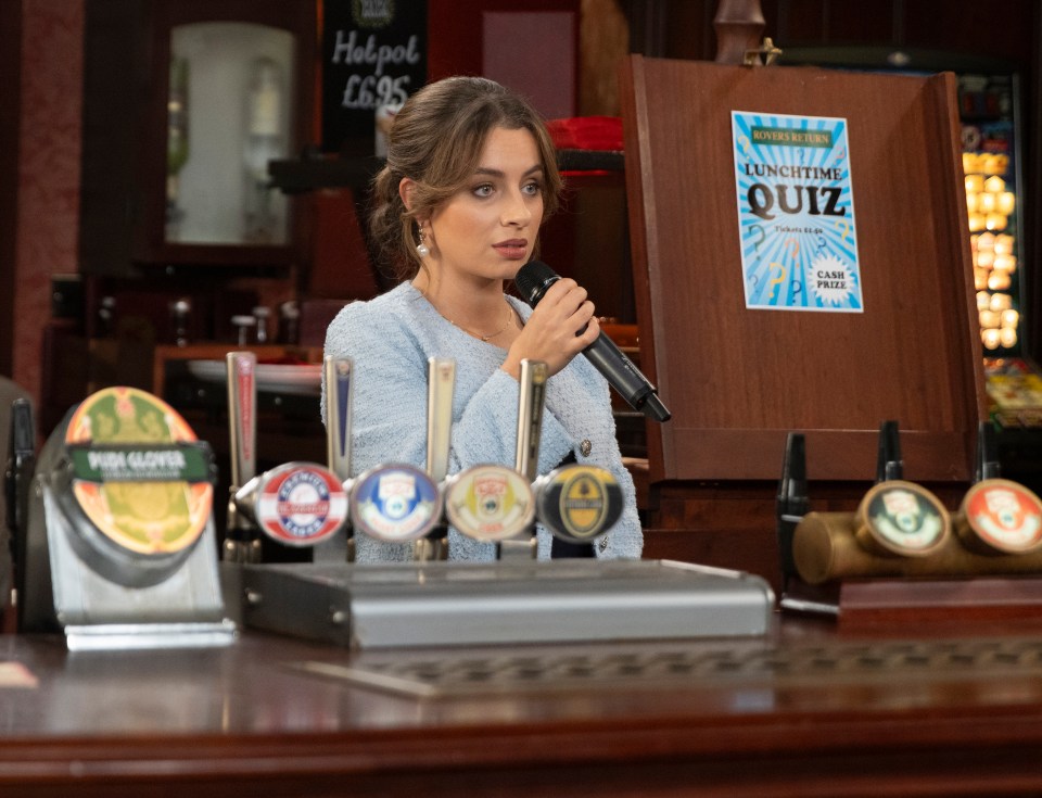 A woman hosting a lunchtime quiz in a pub.