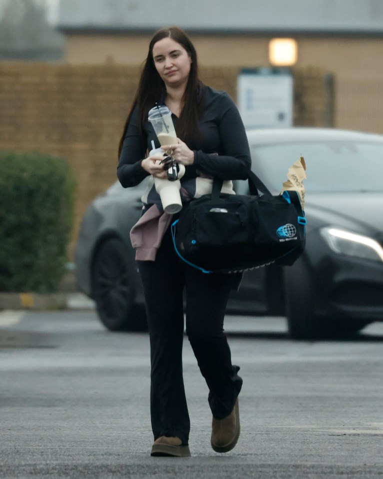 Jacqueline Jossa leaving a gym, carrying a drink and a gym bag.