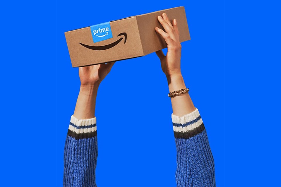 Hands holding up an Amazon Prime package.