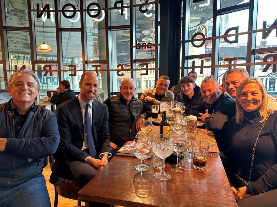 The Prince of Wales with Aston Villa supporters in a pub.