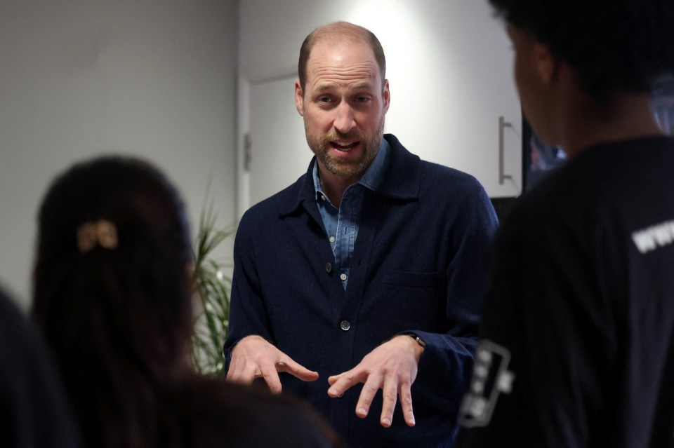 Prince William speaking with young people at a homeless charity.