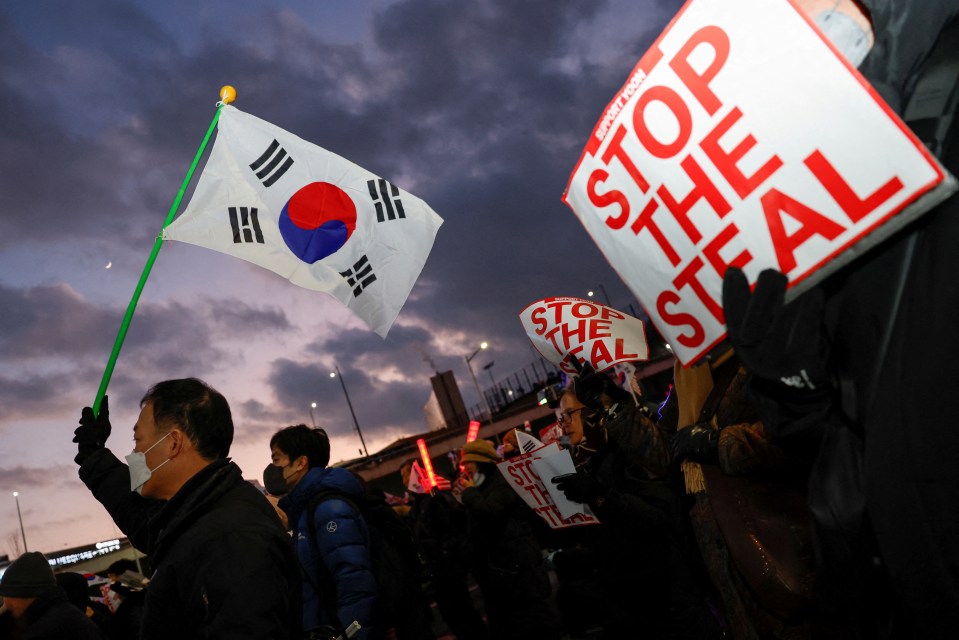 Pro-Yoon protesters hold South Korean flags and ‘STOP THE STEAL’