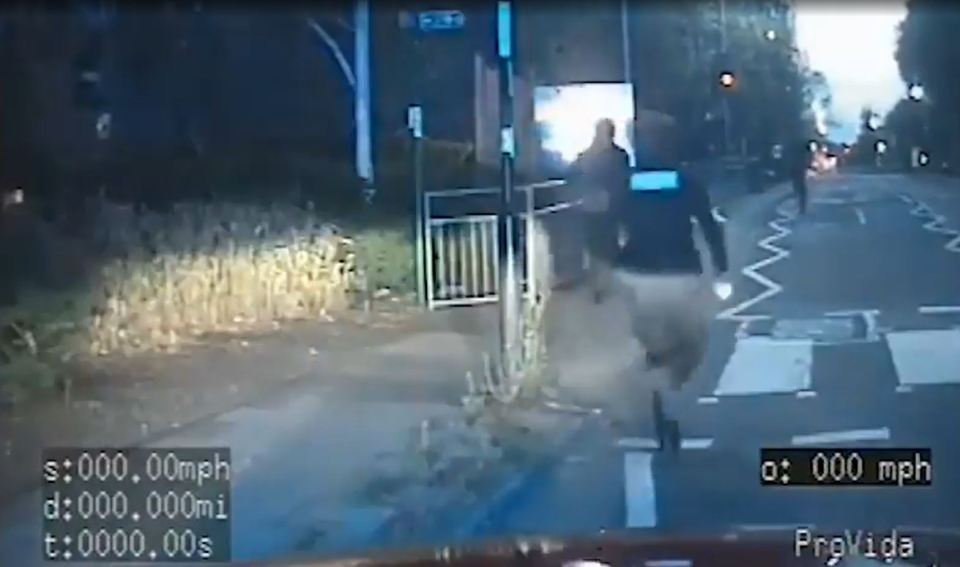 Person running across a crosswalk at night.