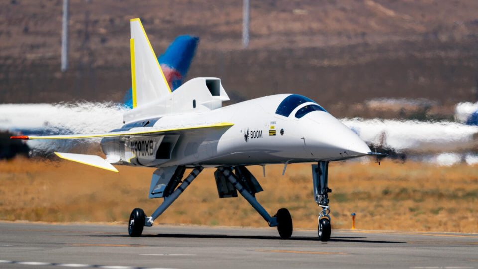 The Boom Supersonic XB-1 aircraft taxiing on a runway.