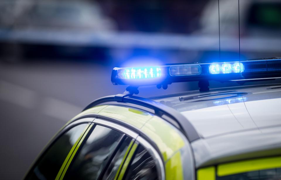 UK police car with flashing blue lights.