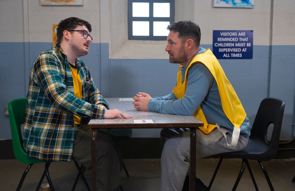 Two men in prison visiting room.