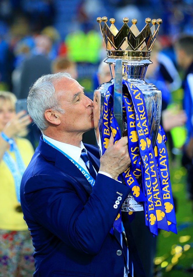 Claudio Ranieri kisses the Barclays Premier League trophy.