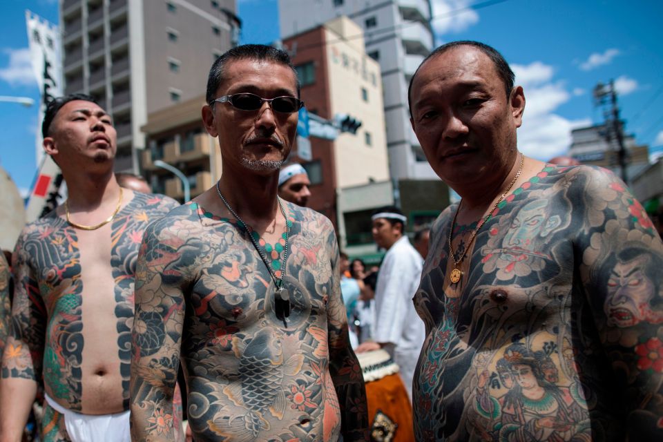 Men with full-body traditional Japanese Irezumi tattoos at the Sanja Matsuri festival.