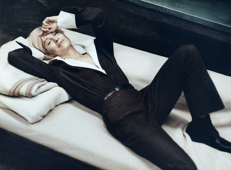 Renée Zellweger lying on a bed.