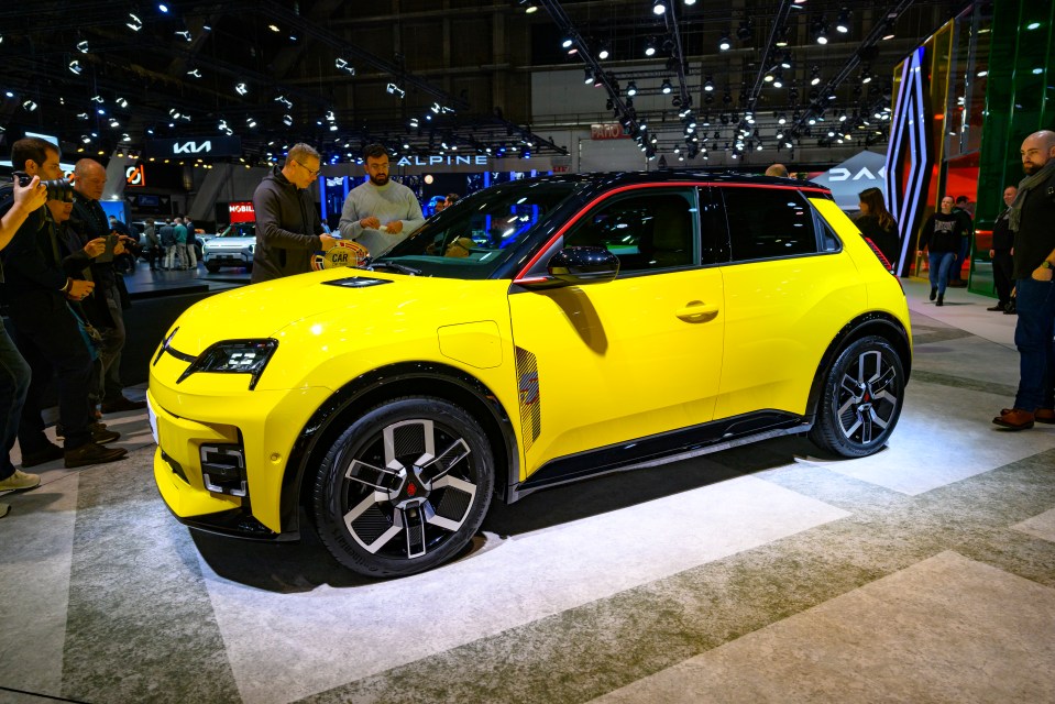 Yellow Renault 5 E-Tech electric car on display.