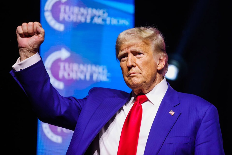 Donald Trump raising his fist at a rally.