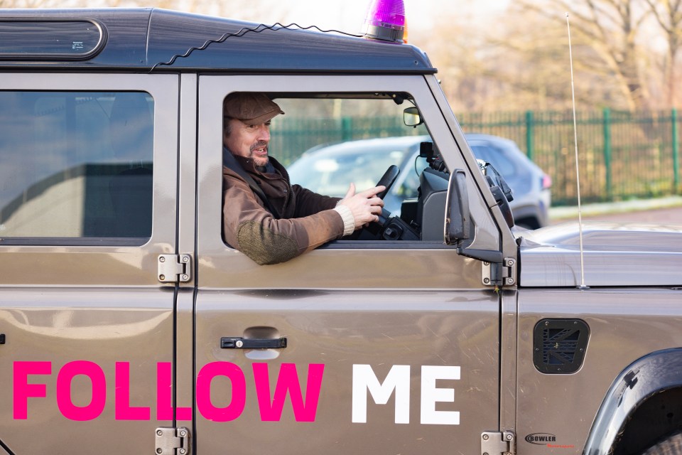 Richard Hammond driving a Land Rover with "Follow Me" on the side.