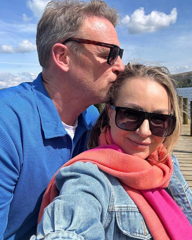 A man kissing a woman on the forehead.