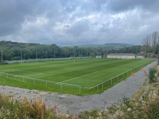 Soccer field with a clubhouse in the background.