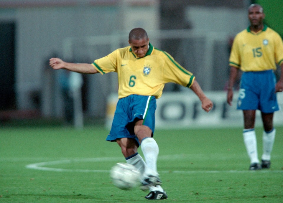 Roberto Carlos of Brazil taking a free kick during a soccer match.