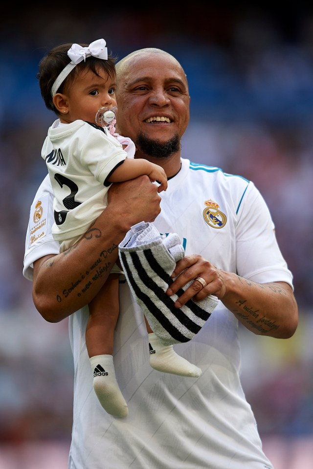 Roberto Carlos of Real Madrid Legends holding his daughter.