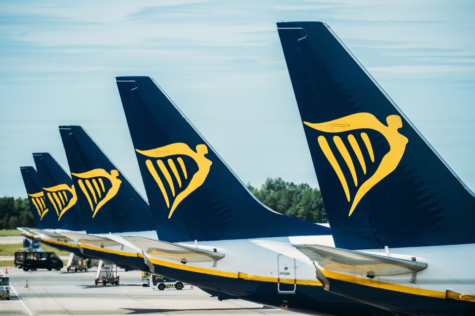 Several Ryanair planes parked at an airport.