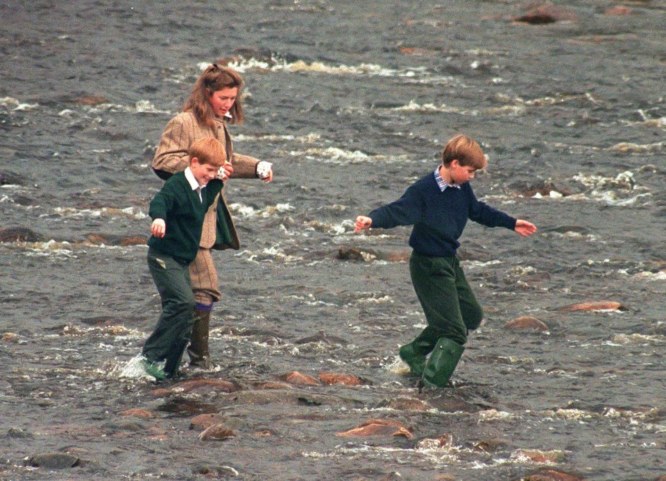 Prince William, Prince Harry, and their nanny wading through a river.