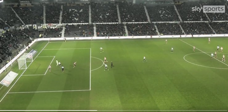 Soccer game in a stadium; players on the field.