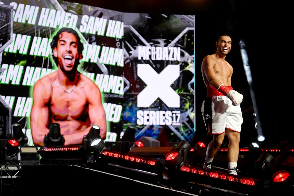 Sami Hamed smiling as he enters a boxing arena.