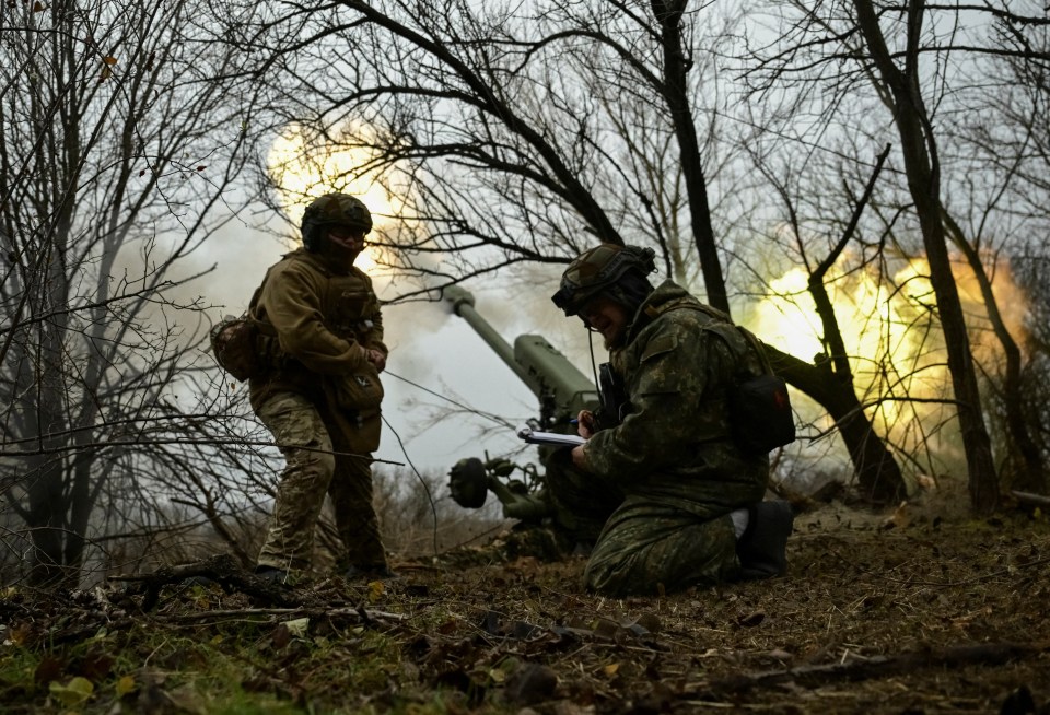 Ukrainian artillery crew firing a howitzer.