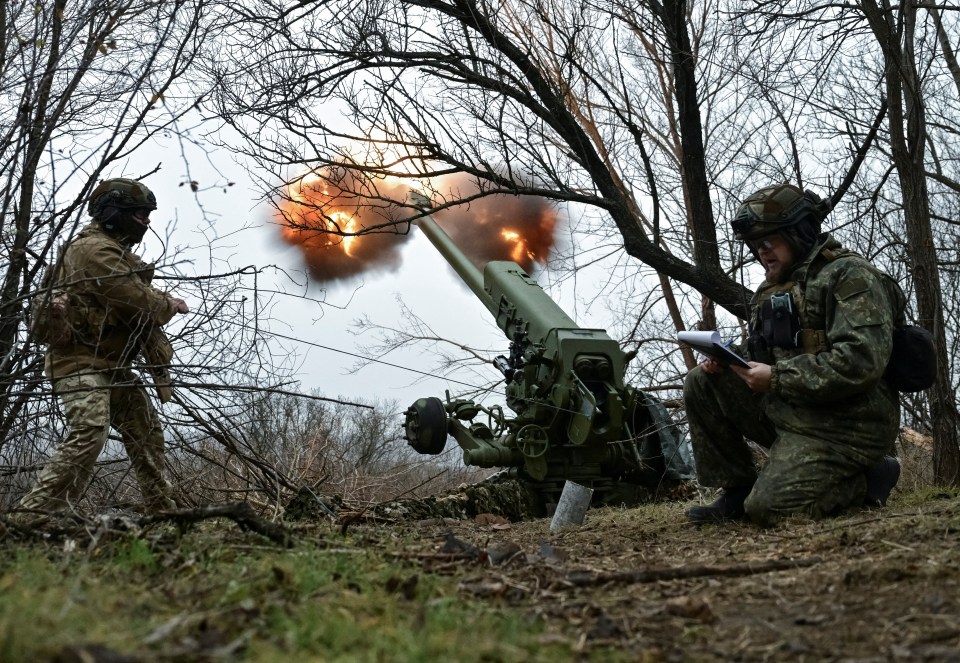 Ukrainian artillery crew firing a howitzer.