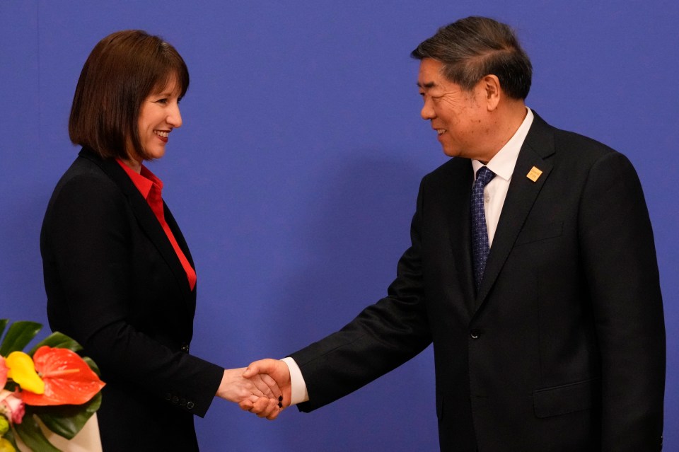 Rachel Reeves and He Lifeng shaking hands at a press conference.