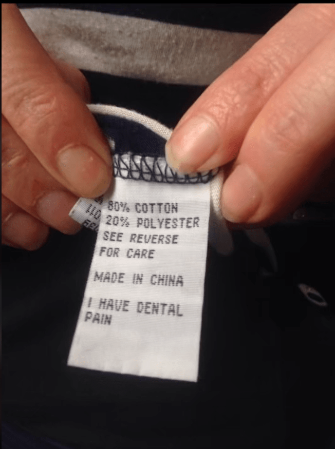 Clothing tag reading "80% cotton, 20% polyester," "Made in China," and "I have dental pain."