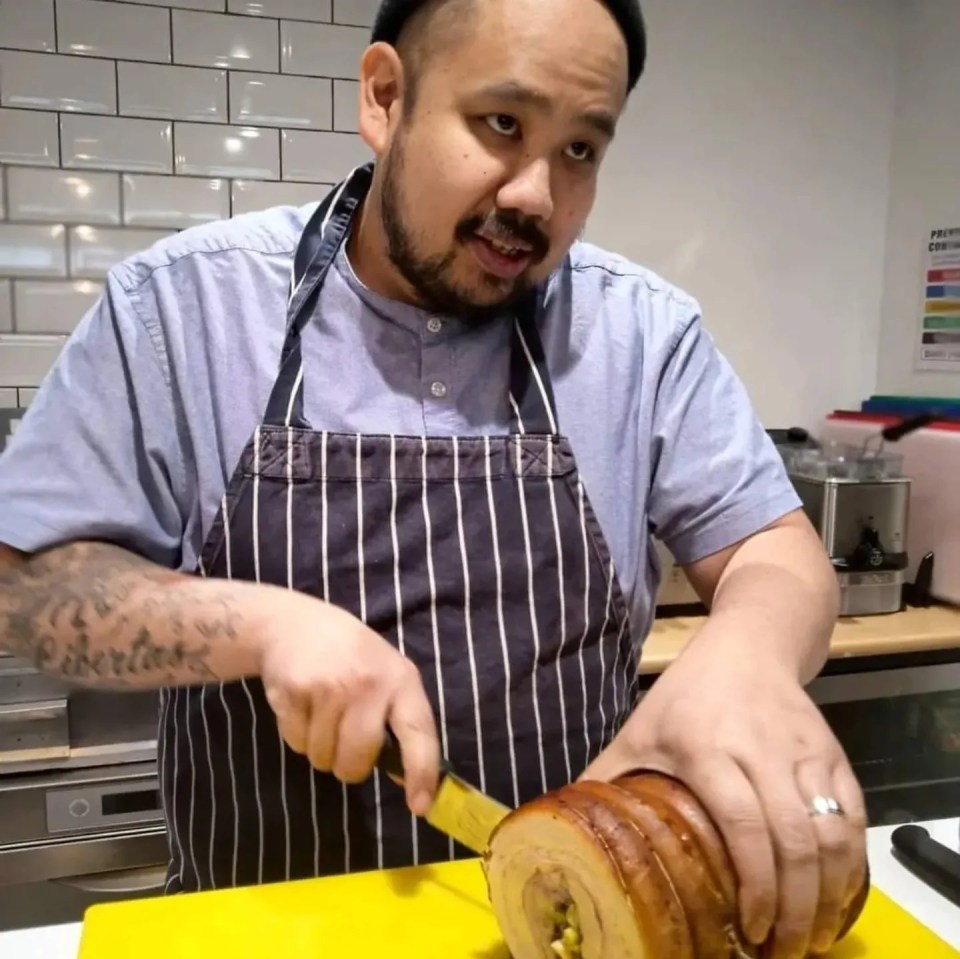 Chef slicing roasted pork belly.