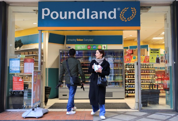 Shoppers walking past a Poundland store in London.